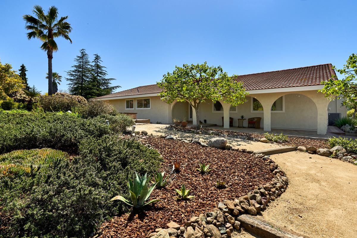 20421 Hunter's Hill Road San Jose, CA 95120 - Photo 7 of 50 a front view of a house with a yard