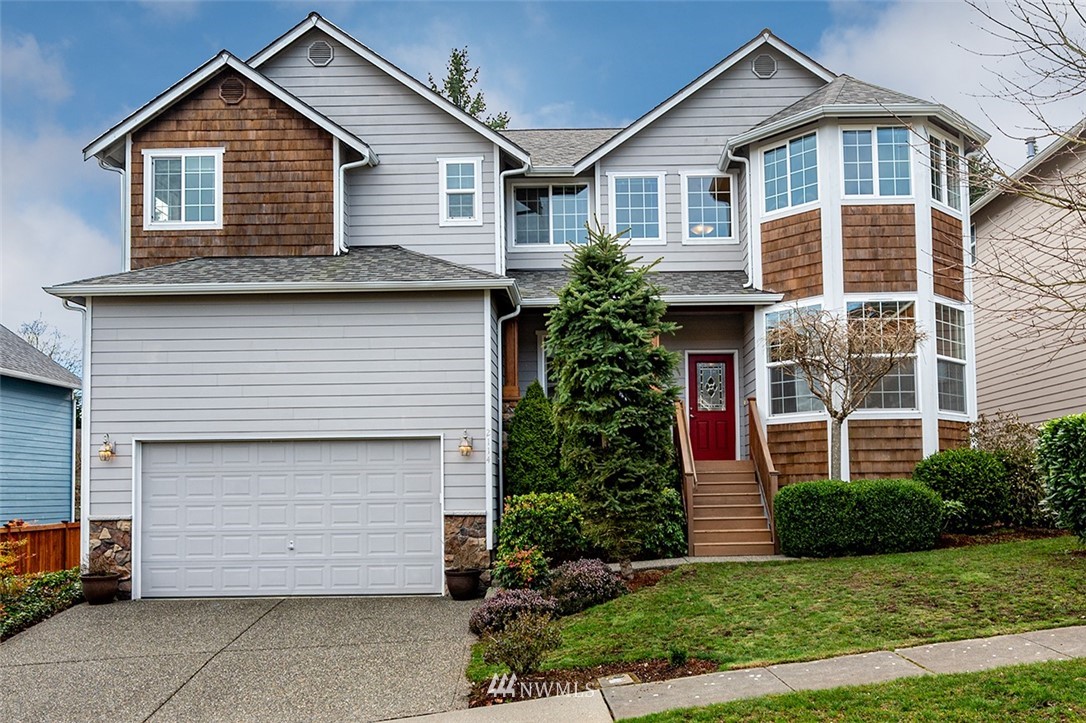 2114 241st Street Southwest Bothell, WA 98021 - Photo 2 of 32 a front view of a house with a yard and garage