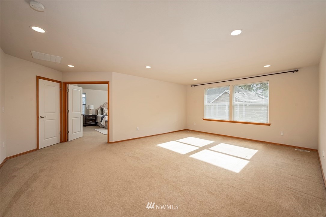 2114 241st Street Southwest Bothell, WA 98021 - Photo 15 of 32 an empty room with windows and pillars in it
