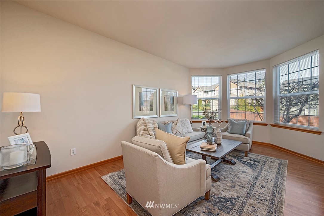 2114 241st Street Southwest Bothell, WA 98021 - Photo 5 of 32 a living room with furniture a lamp wooden floor and a table