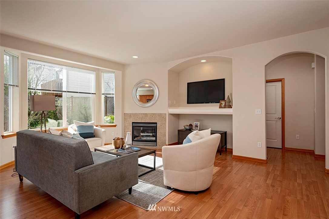 2114 241st Street Southwest Bothell, WA 98021 - Photo 6 of 32 a living room with furniture a fireplace and a flat screen tv