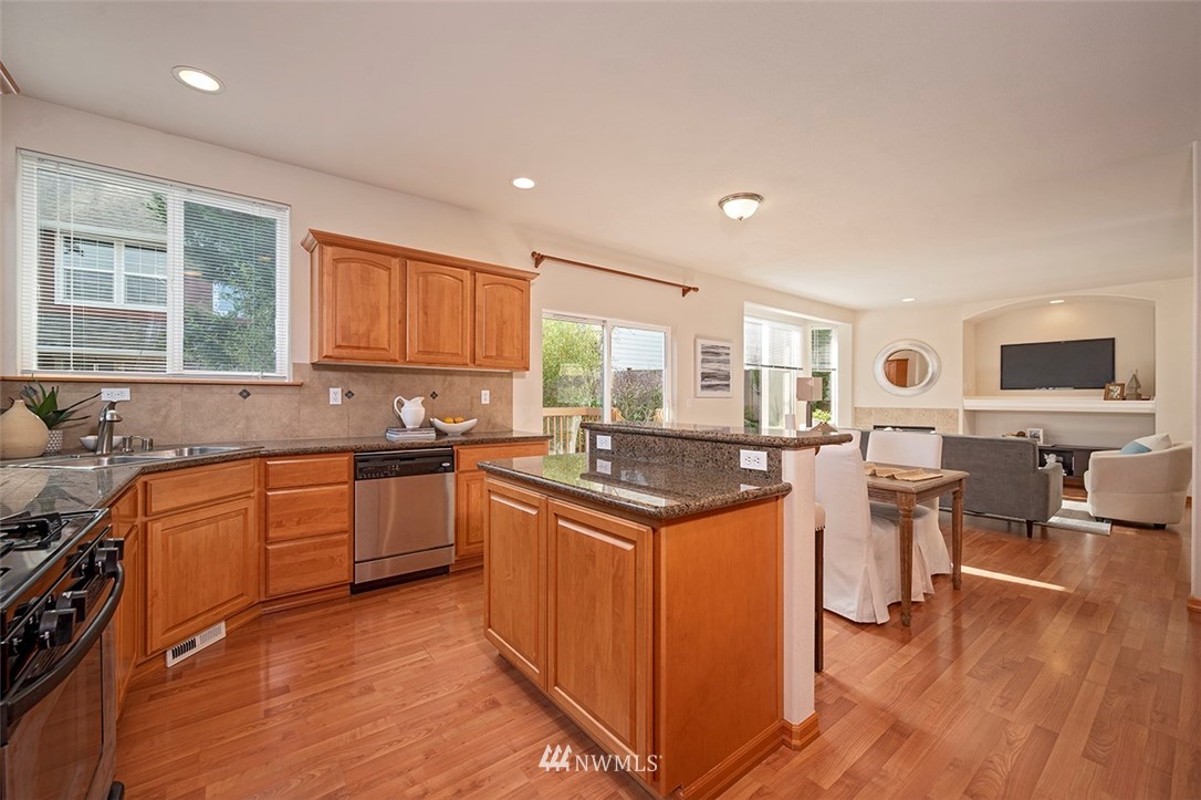 2114 241st Street Southwest Bothell, WA 98021 - Photo 10 of 32 a kitchen with stainless steel appliances granite countertop a stove and a sink