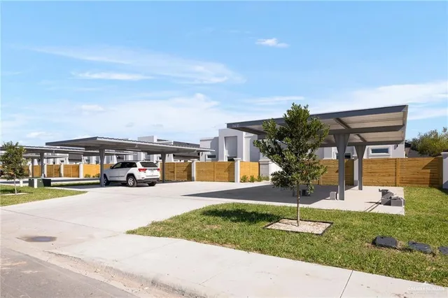 a front view of a house with a yard and table and chairs