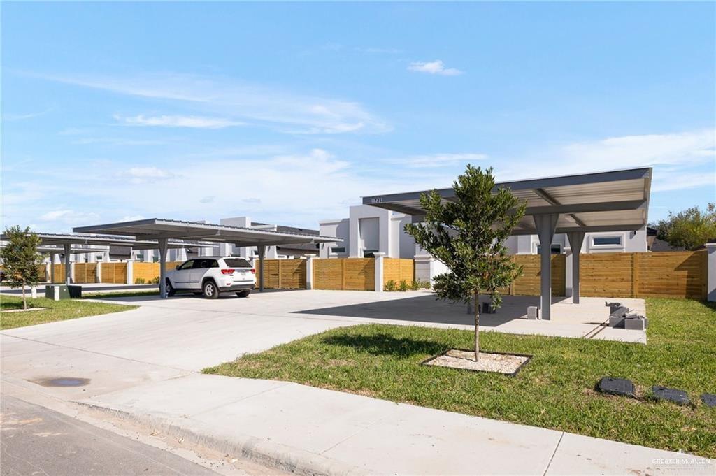1721 Monaco Drive, Unit 4 San Juan, TX 78589 - Photo 2 of 17 a front view of a house with a yard and table and chairs
