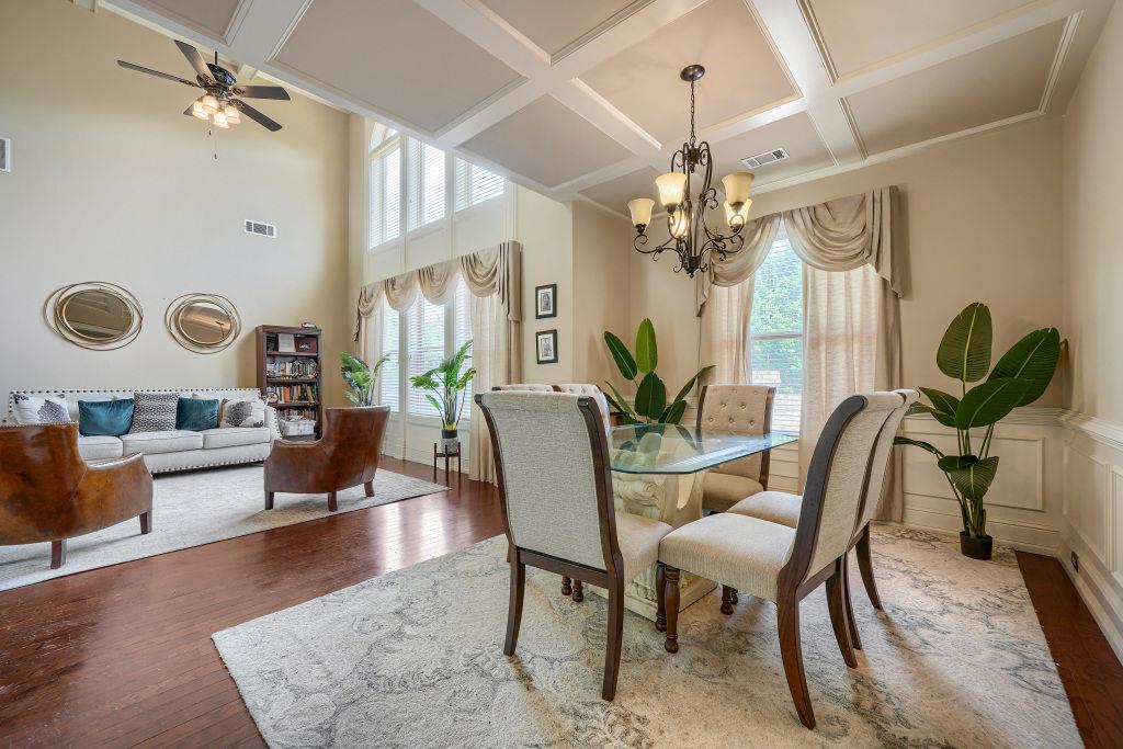 345 Masters Club Boulevard Hampton, GA 30228 - Photo 9 of 30 a view of a dining room with furniture a chandelier and wooden floor