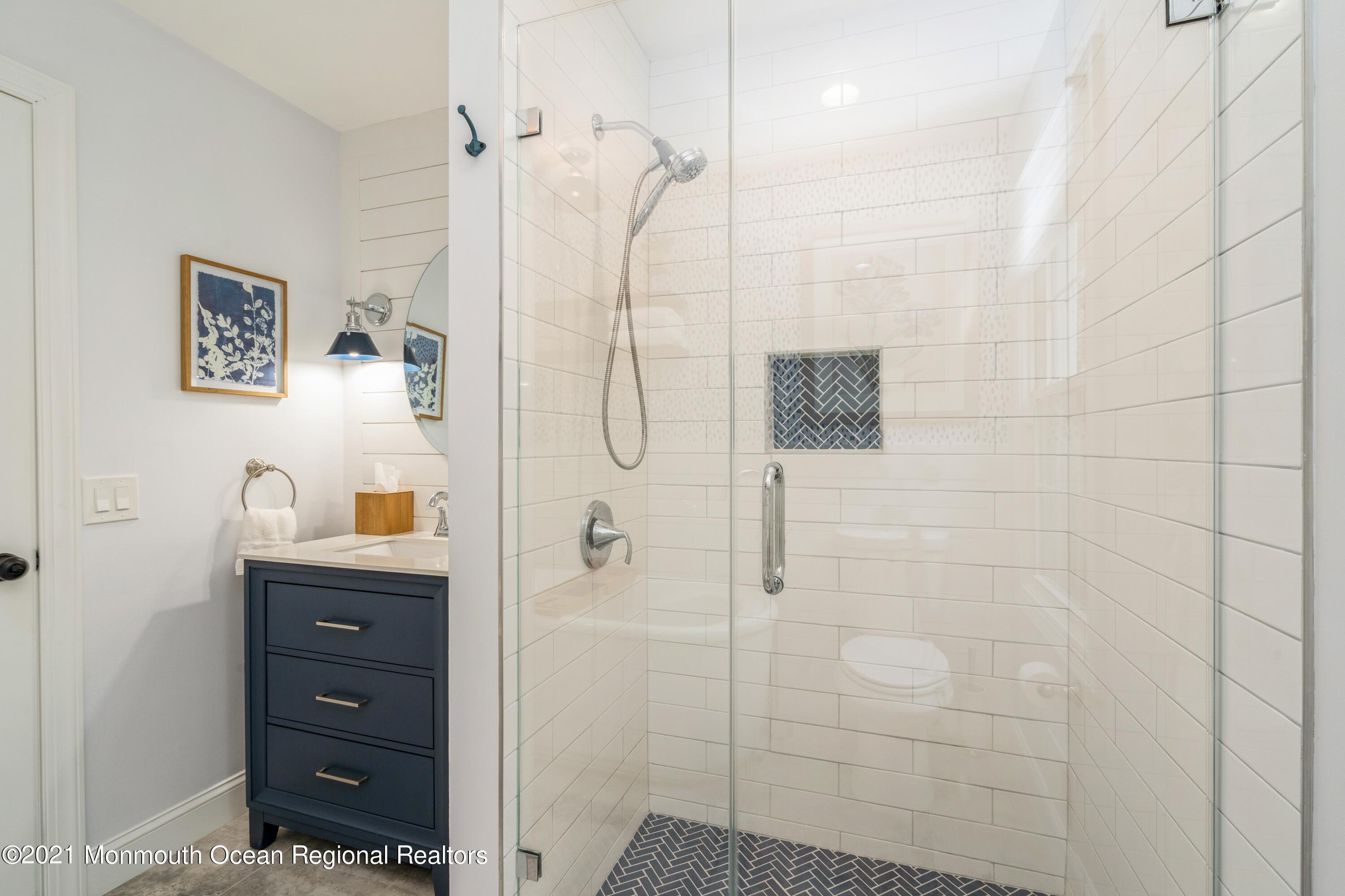 6 Brookside Road Millstone Township, NJ 08510 - Photo 12 of 27 a bathroom with a shower a sink and mirror