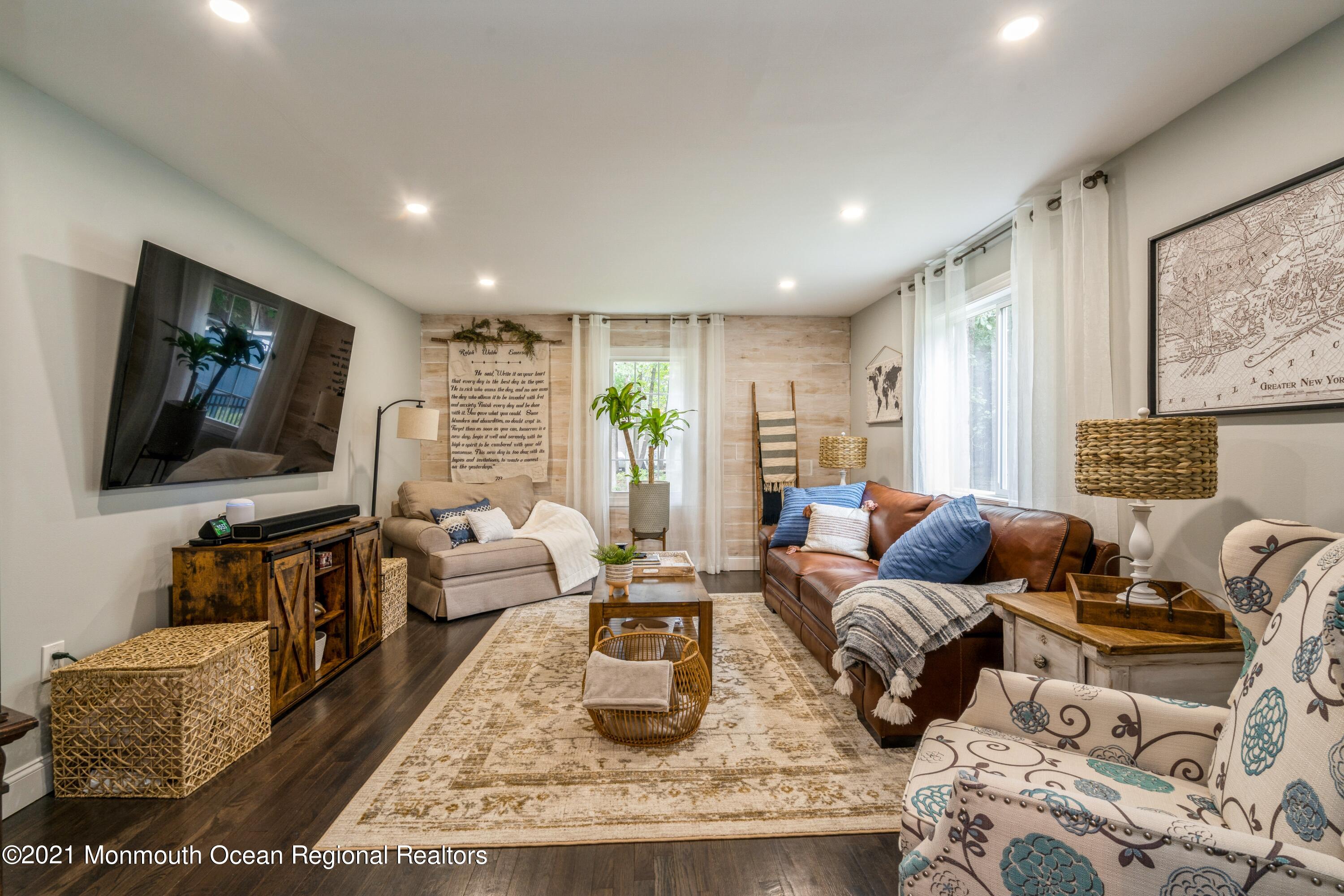 6 Brookside Road Millstone Township, NJ 08510 - Photo 16 of 27 a living room with furniture and a flat screen tv