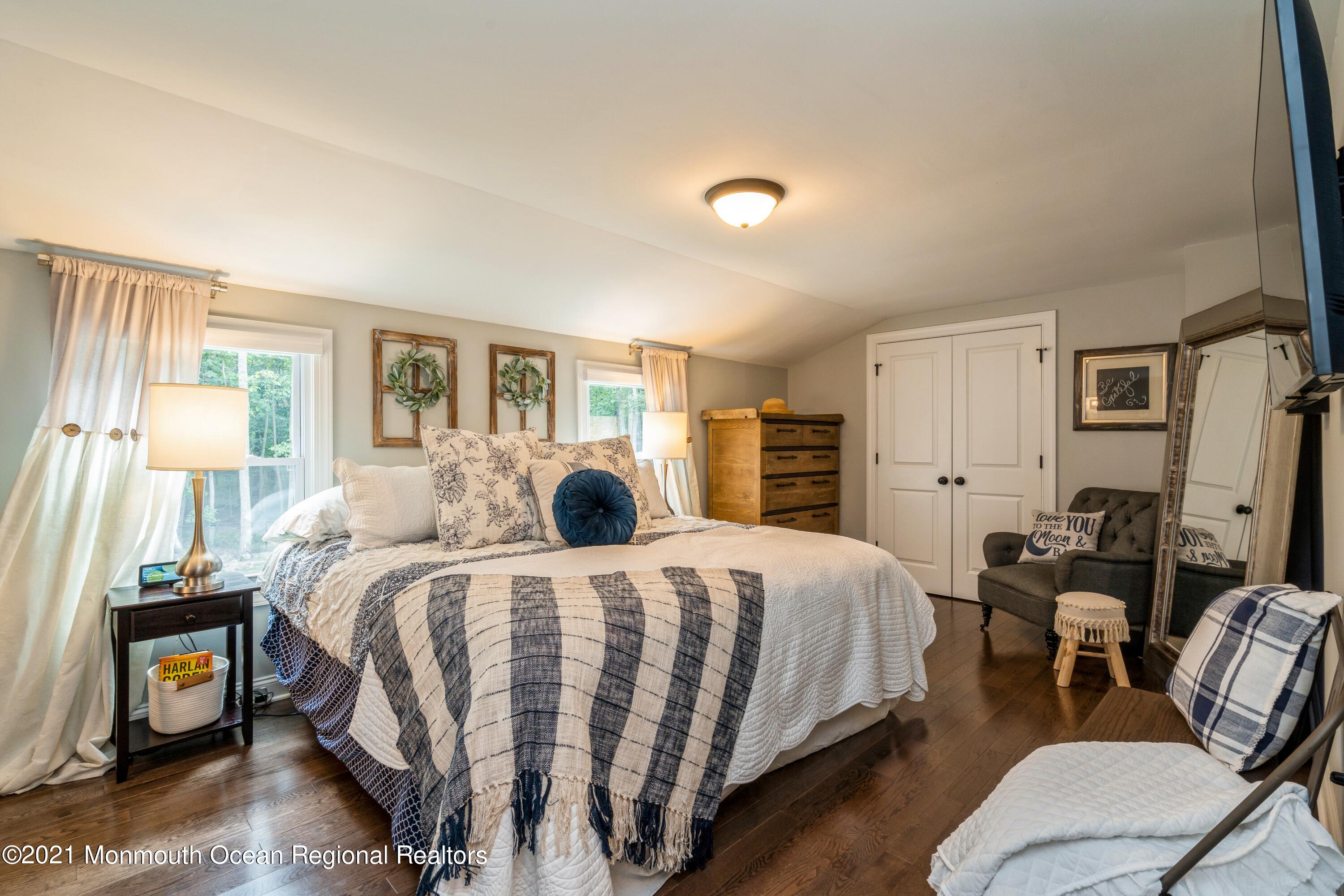 6 Brookside Road Millstone Township, NJ 08510 - Photo 18 of 27 a bedroom with a bed and wooden floor