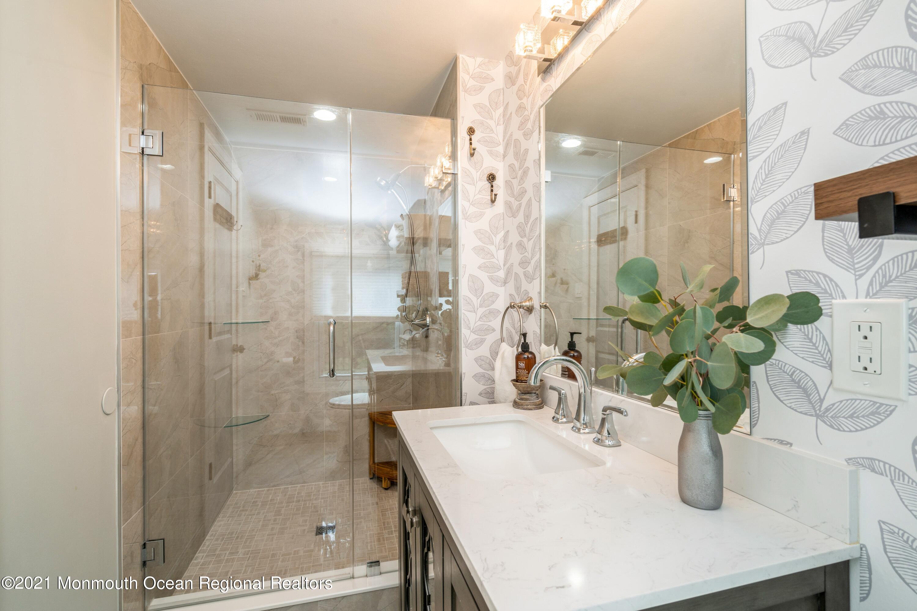 6 Brookside Road Millstone Township, NJ 08510 - Photo 20 of 27 a bathroom with a shower a sink and a mirror