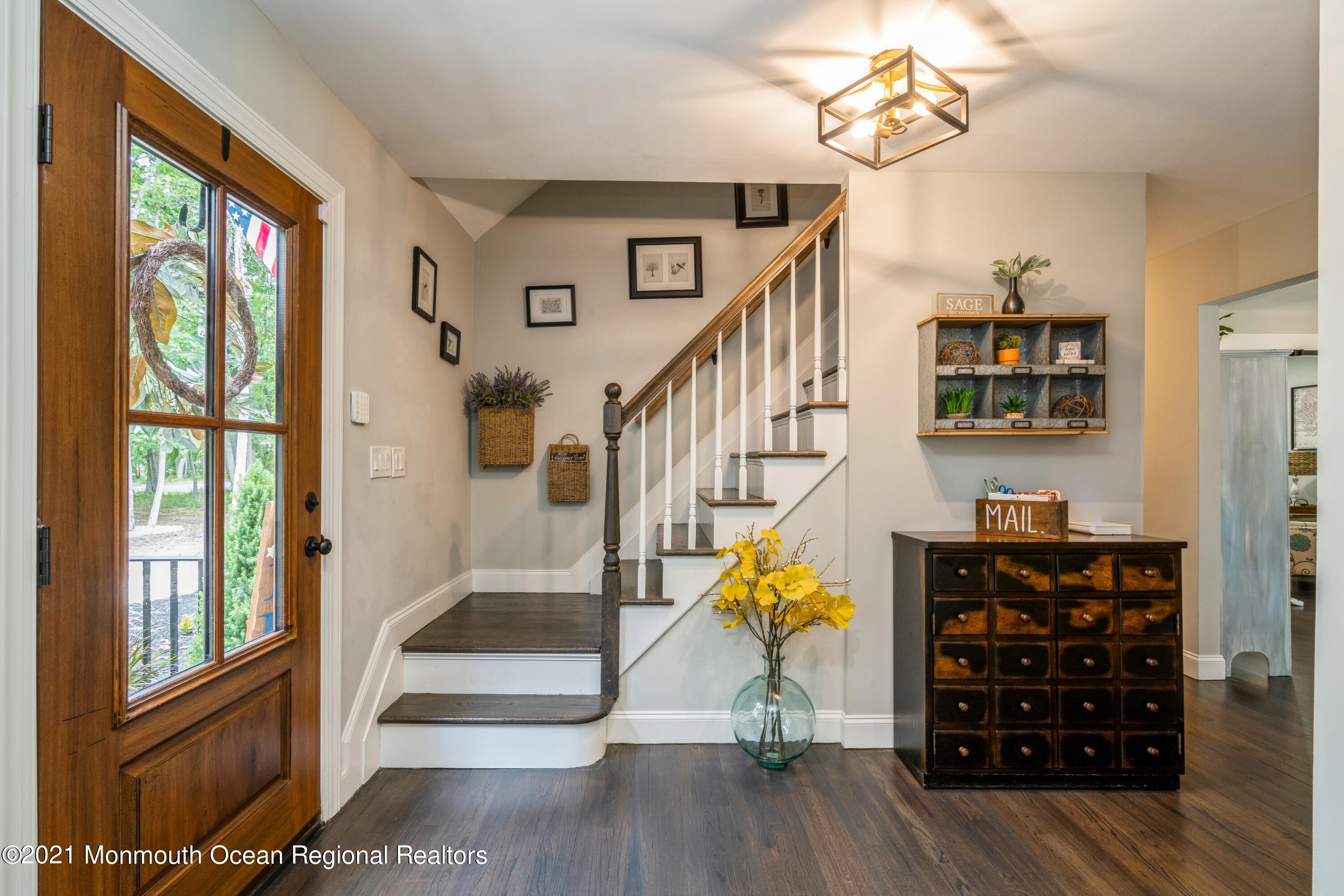 6 Brookside Road Millstone Township, NJ 08510 - Photo 3 of 27 a view of entryway with wooden floor and stairs