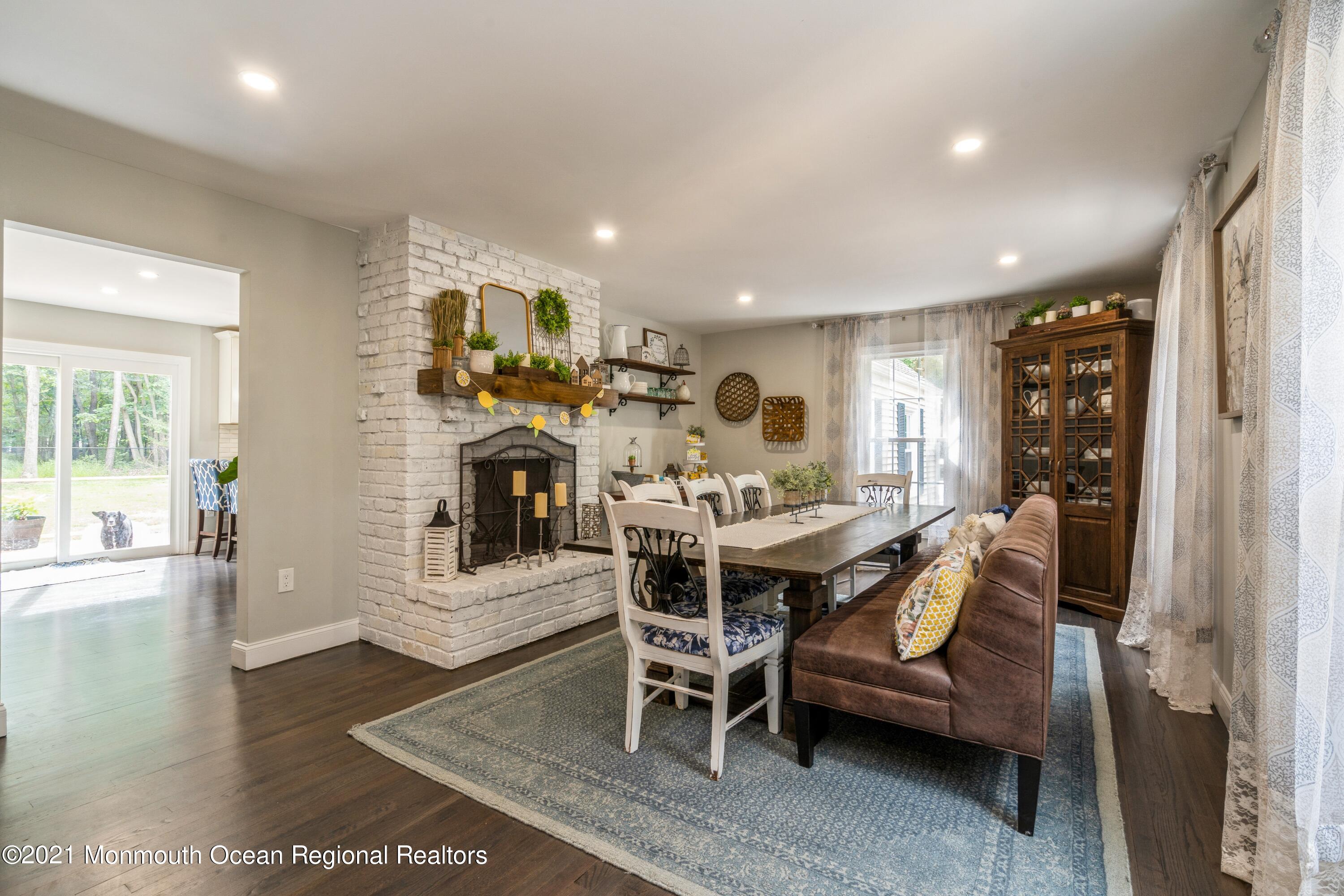 6 Brookside Road Millstone Township, NJ 08510 - Photo 4 of 27 a view of a dining room with furniture a fireplace and wooden floor