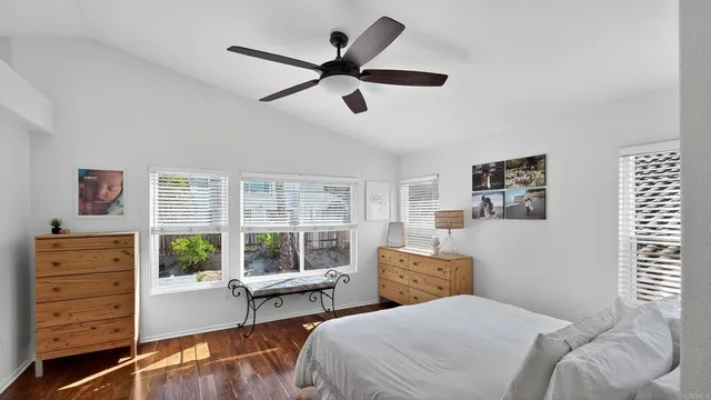 a bedroom with furniture and a wooden floor
