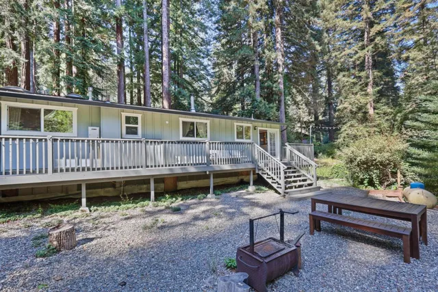 a backyard of a house with barbeque oven and outdoor seating