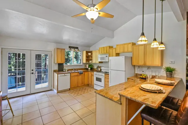 a kitchen with a table chairs and a chandelier