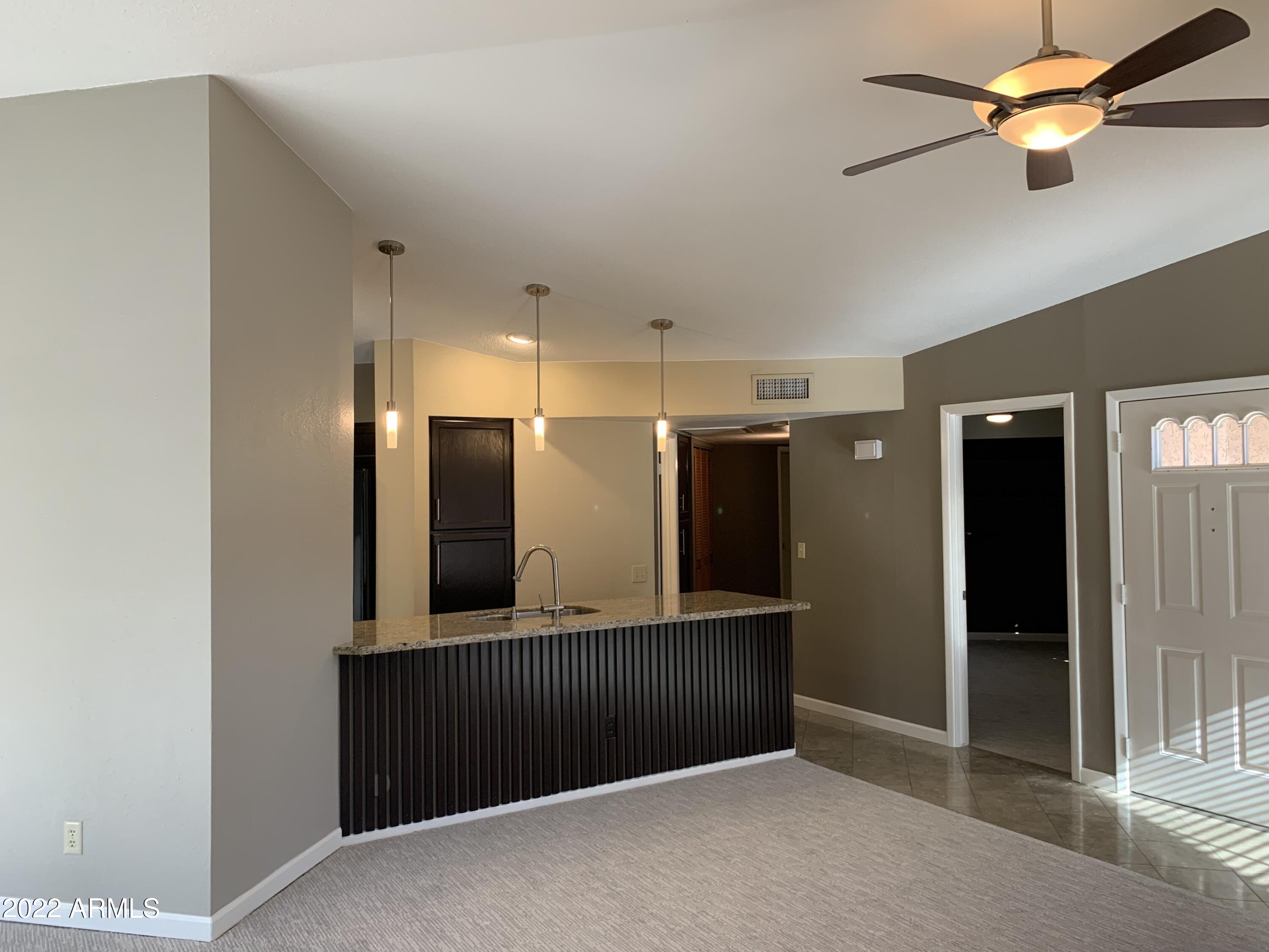 4302 East Bannock Street Phoenix, AZ 85044 - Photo 15 of 55 a view of a hallway with a kitchen