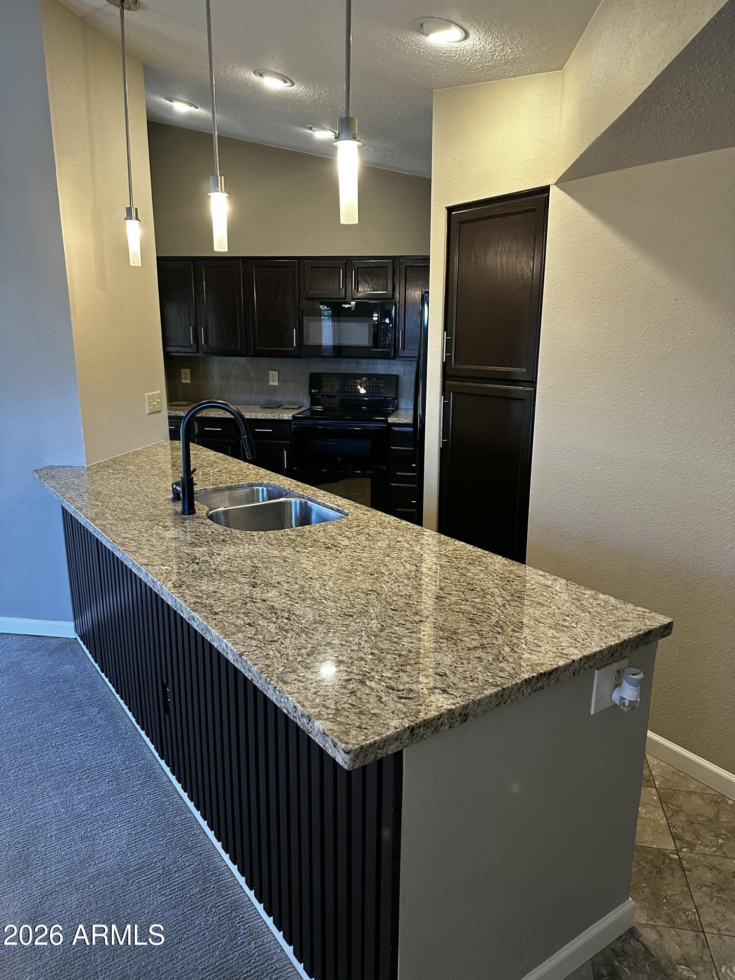 4302 East Bannock Street Phoenix, AZ 85044 - Photo 23 of 55 a kitchen with center island and stainless steel appliances