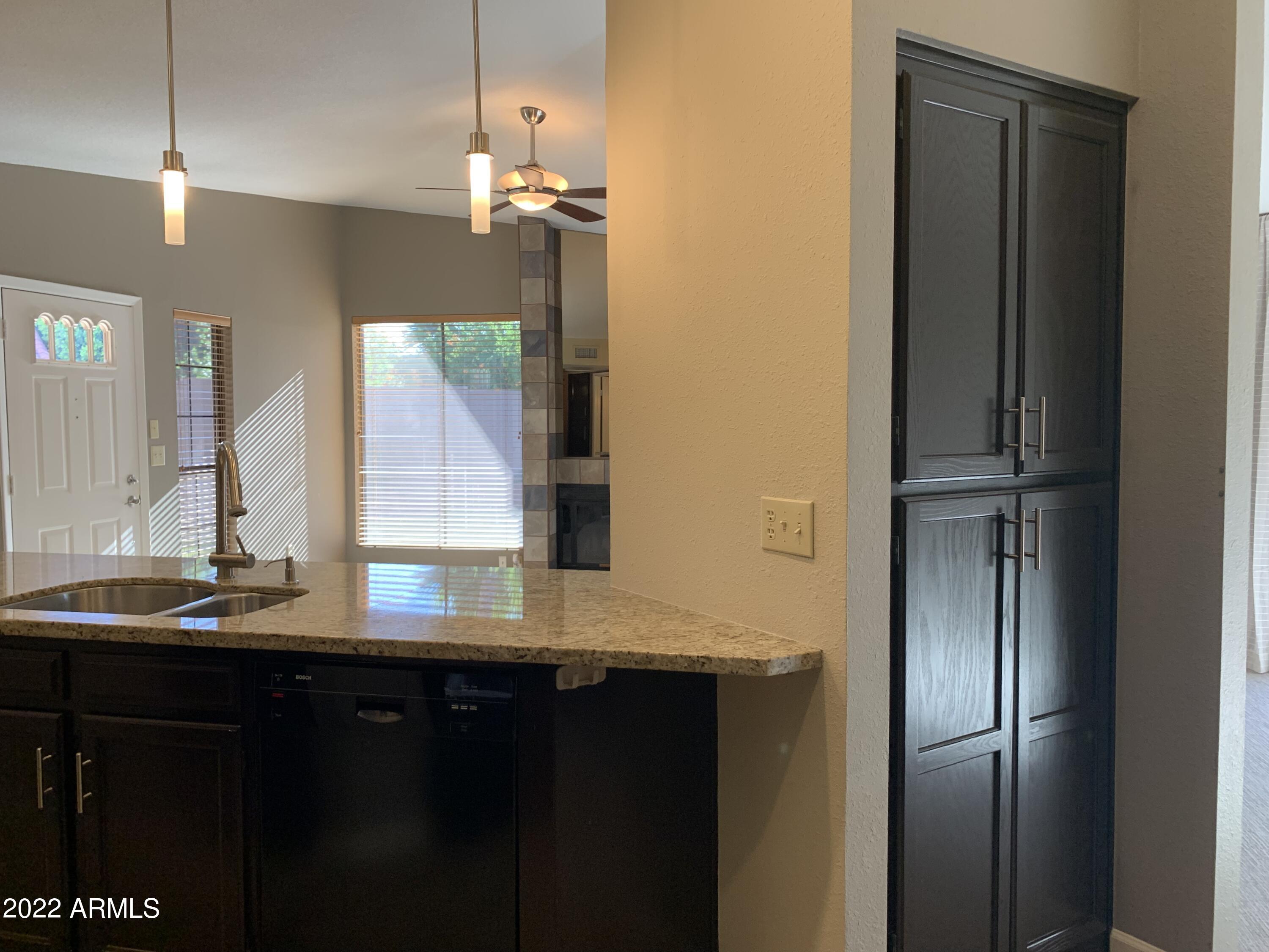 4302 East Bannock Street Phoenix, AZ 85044 - Photo 26 of 55 a bathroom with a granite countertop sink and a mirror