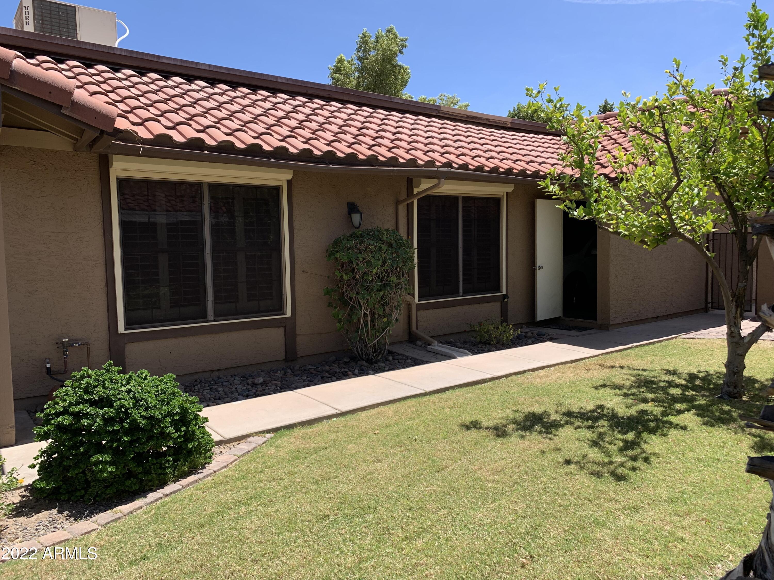 4302 East Bannock Street Phoenix, AZ 85044 - Photo 9 of 55 a front view of a house with a yard