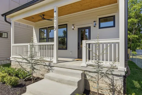 a view of a house with wooden fence