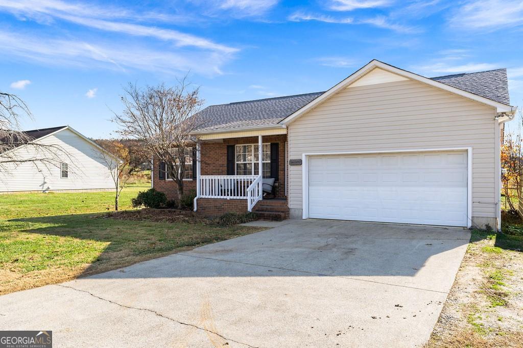 a front view of a house with a yard and garage