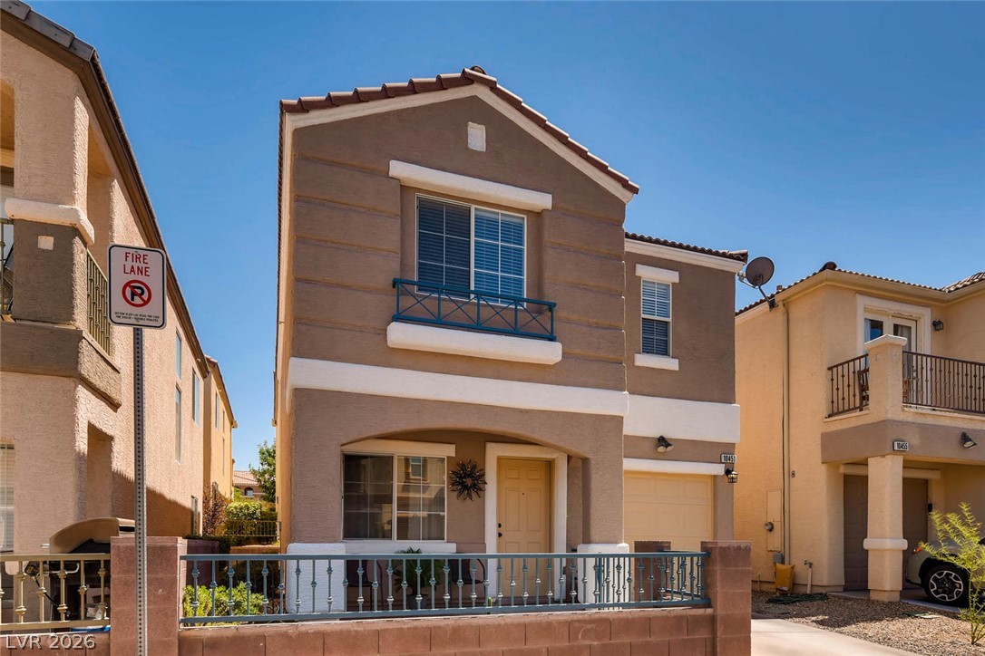 10451 Processor Court Las Vegas, NV 89129 - Photo 1 of 28 A charming exterior with stucco siding and a classic tile roof, showcasing a neat fence.
