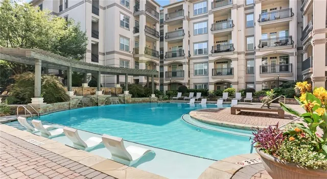 a front view of a building with fountain and outdoor seating