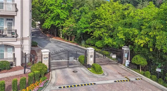 a view of a small yard in front of a house with large tree