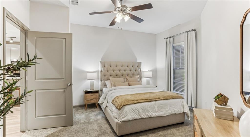 2910 Clairmont Road, Unit PLAN 6 Atlanta, GA 30329 - Photo 25 of 29 a bedroom with a bed and a chandelier