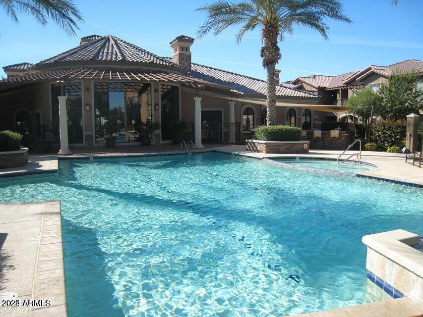 14250 West Wigwam Boulevard, Unit 1421 Litchfield Park, AZ 85340 - Photo 1 of 15 a view of a house with backyard and porch