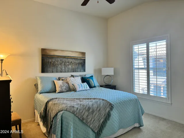 a bedroom with a bed and window