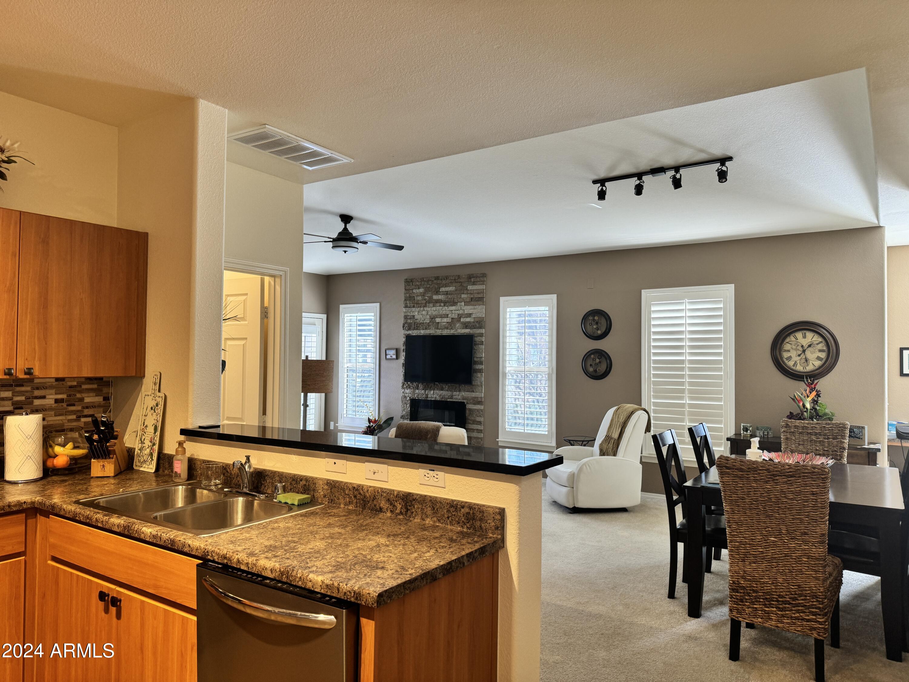 14250 West Wigwam Boulevard, Unit 1421 Litchfield Park, AZ 85340 - Photo 7 of 15 a view of living room filled with furniture and window