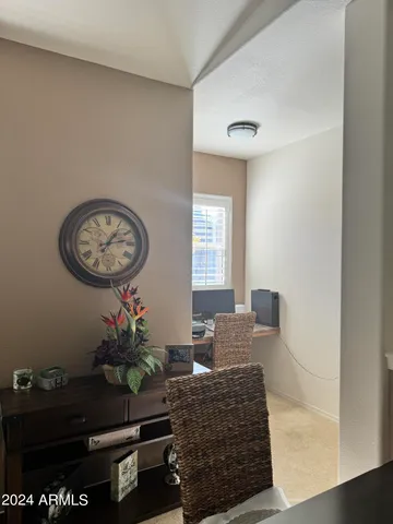 a living room with furniture a window and a potted plant