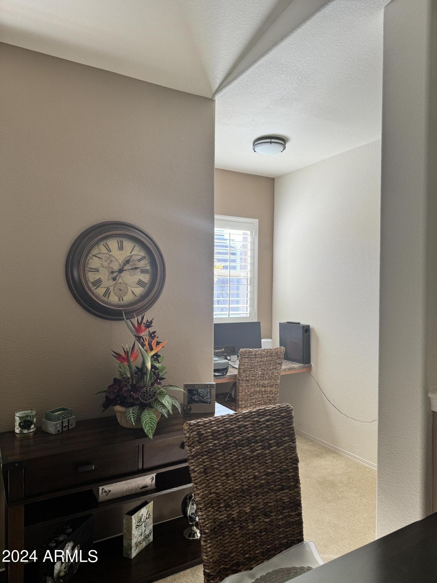 14250 West Wigwam Boulevard, Unit 1421 Litchfield Park, AZ 85340 - Photo 9 of 15 a living room with furniture a window and a potted plant