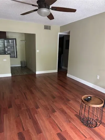 a view of a livingroom with furniture and wooden floor