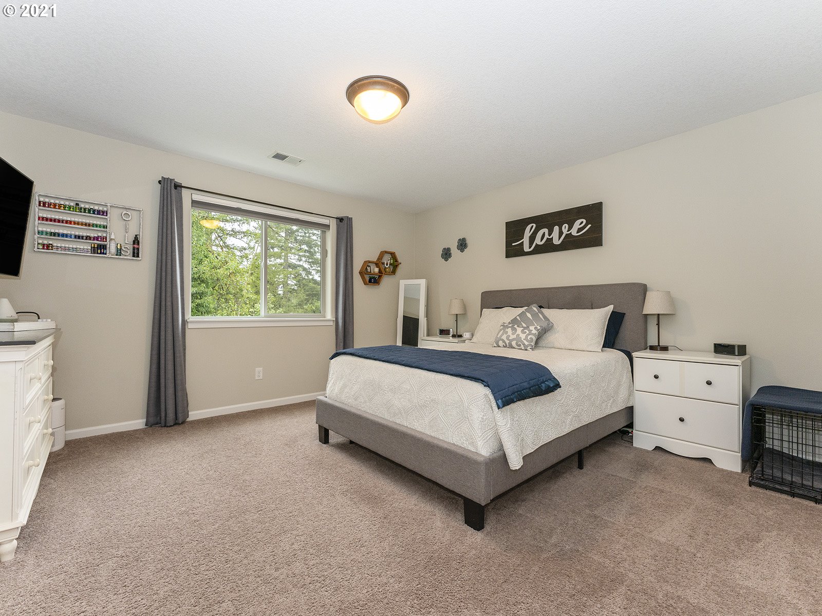 2813 Southeast Baker Avenue Gresham, OR 97080 - Photo 16 of 32 a bedroom with a bed and a flat tv screen on dresser