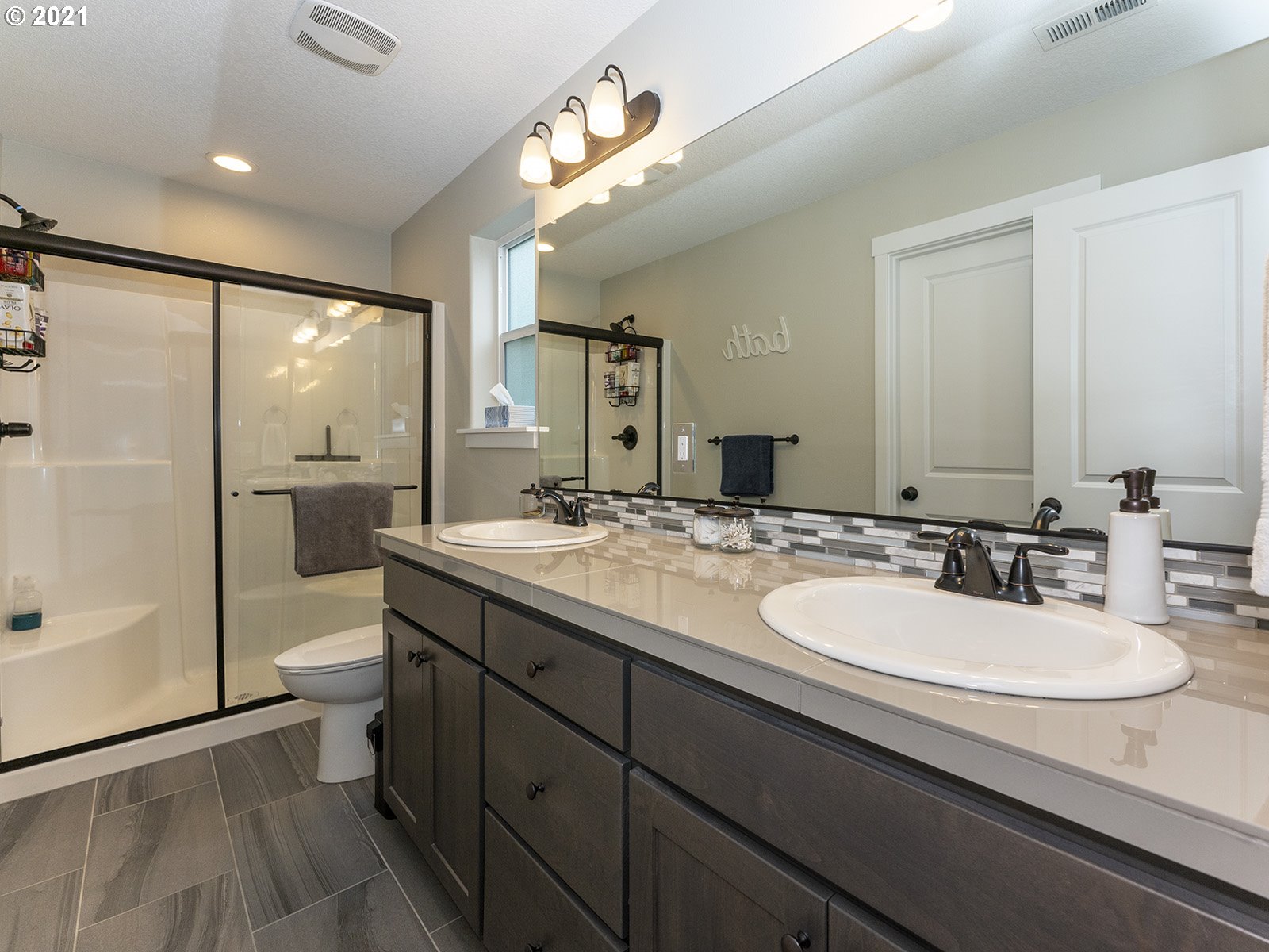 2813 Southeast Baker Avenue Gresham, OR 97080 - Photo 18 of 32 a bathroom with a double vanity sink toilet and shower