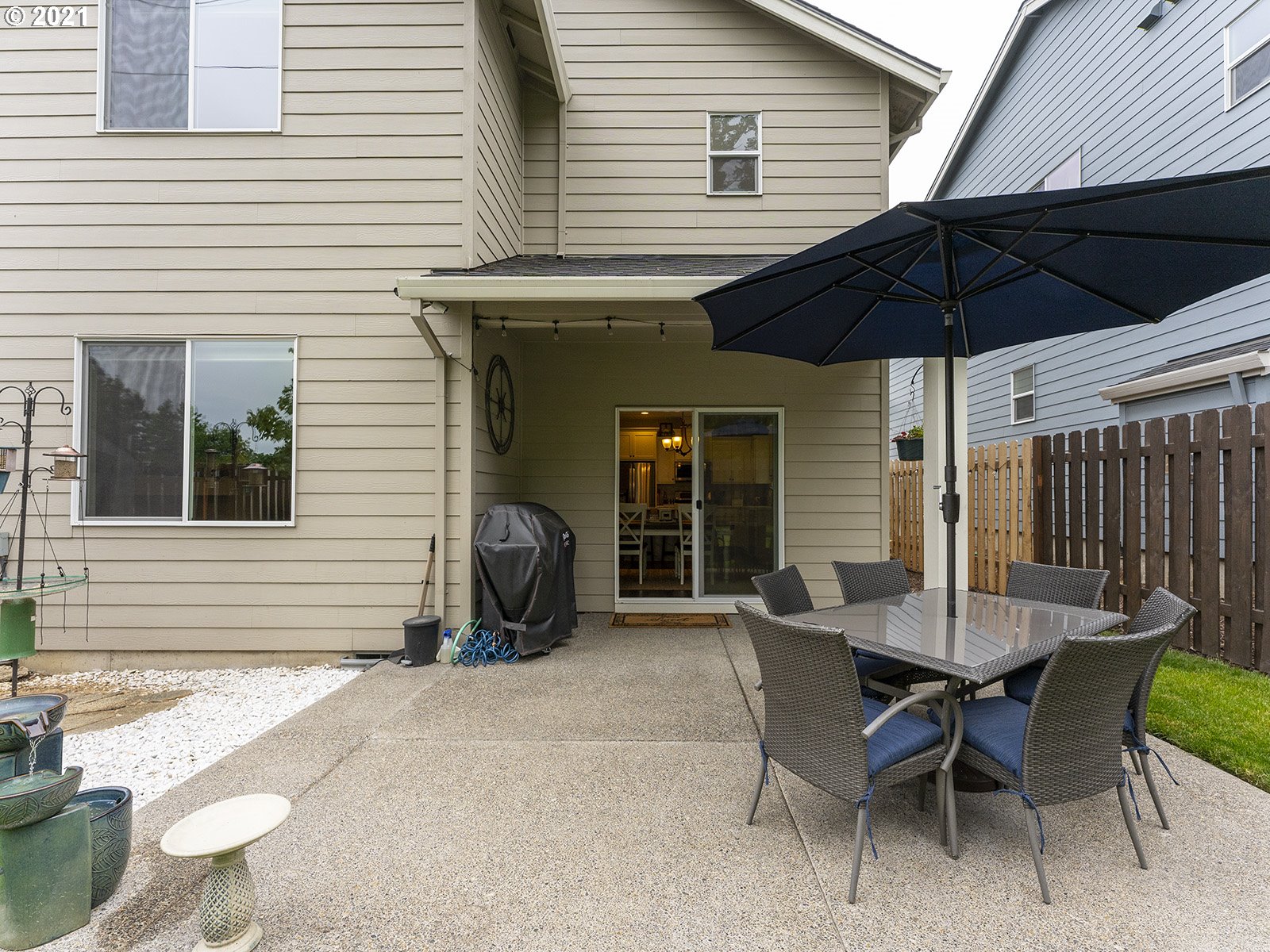 2813 Southeast Baker Avenue Gresham, OR 97080 - Photo 32 of 32 a view of a patio with a table and chairs under an umbrella