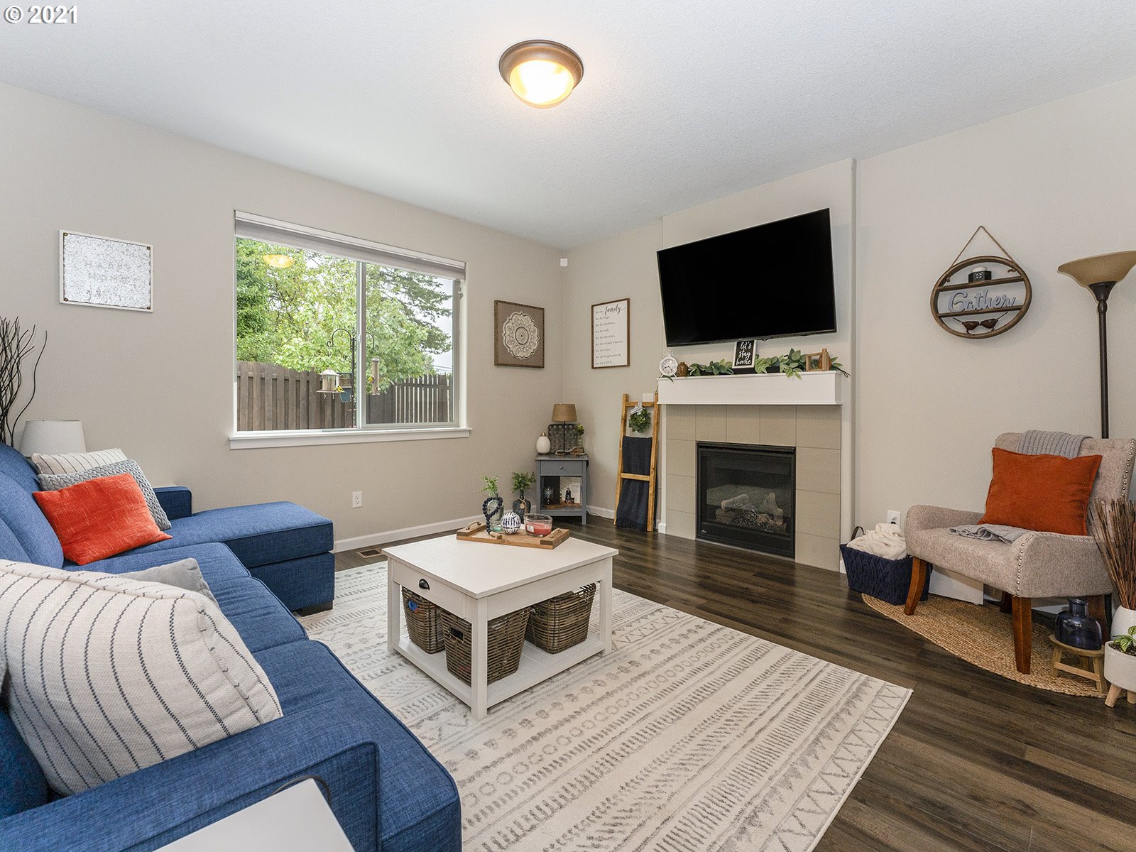 2813 Southeast Baker Avenue Gresham, OR 97080 - Photo 7 of 32 a living room with furniture a flat screen tv and a fireplace