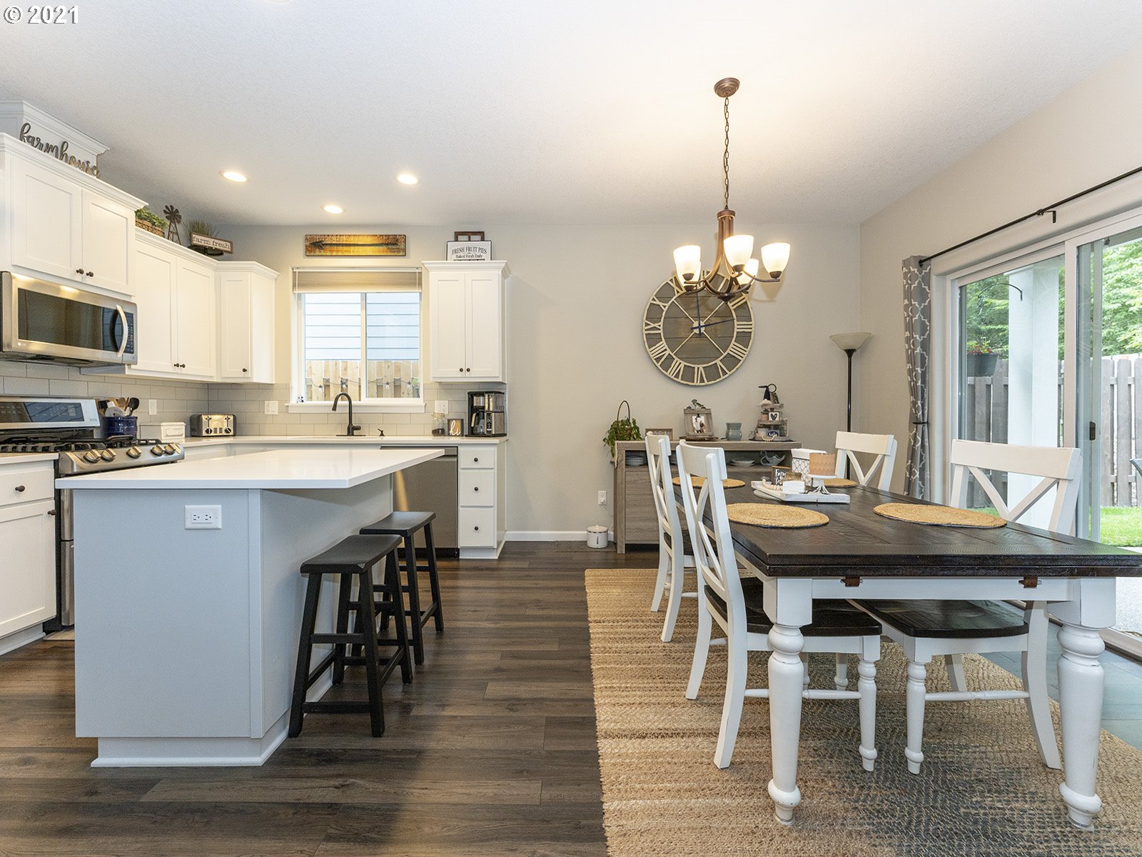 2813 Southeast Baker Avenue Gresham, OR 97080 - Photo 8 of 32 a dining room with stainless steel appliances kitchen island granite countertop a dining table chairs and a refrigerator