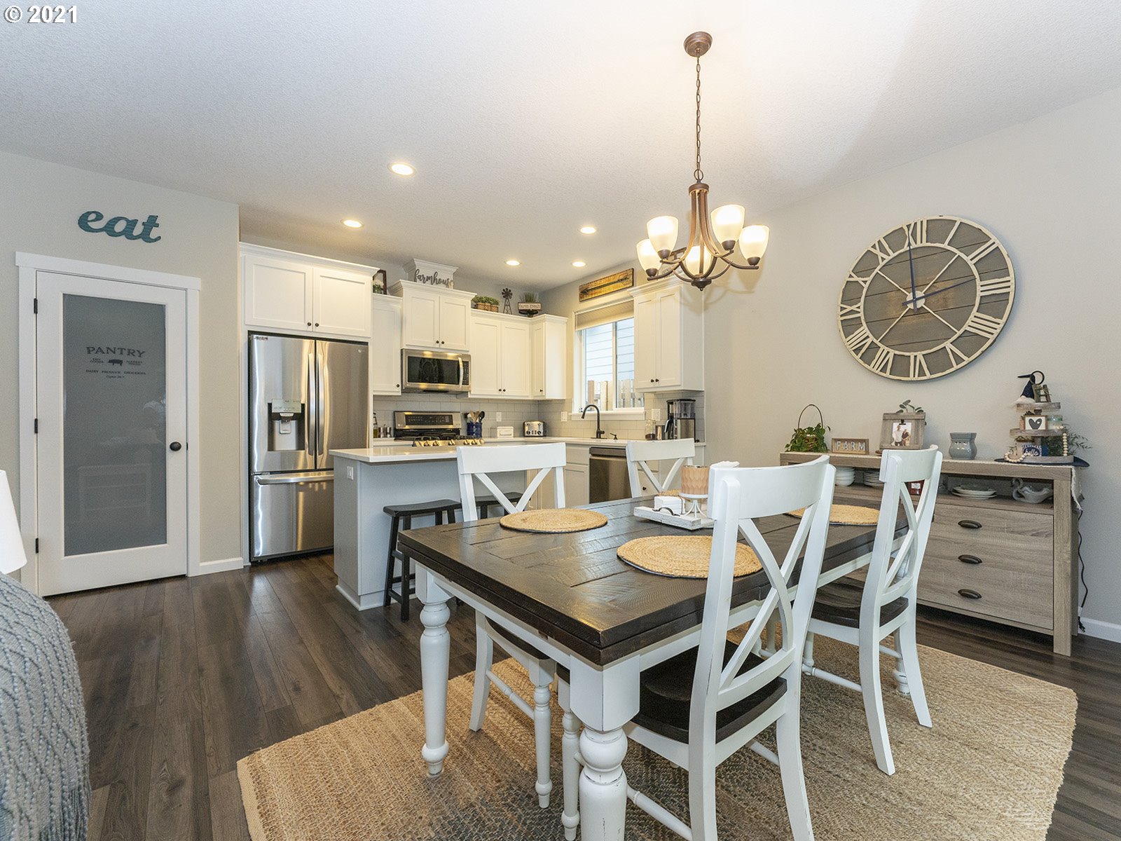 2813 Southeast Baker Avenue Gresham, OR 97080 - Photo 9 of 32 a view of a dining room and livingroom with furniture wooden floor a chandelier