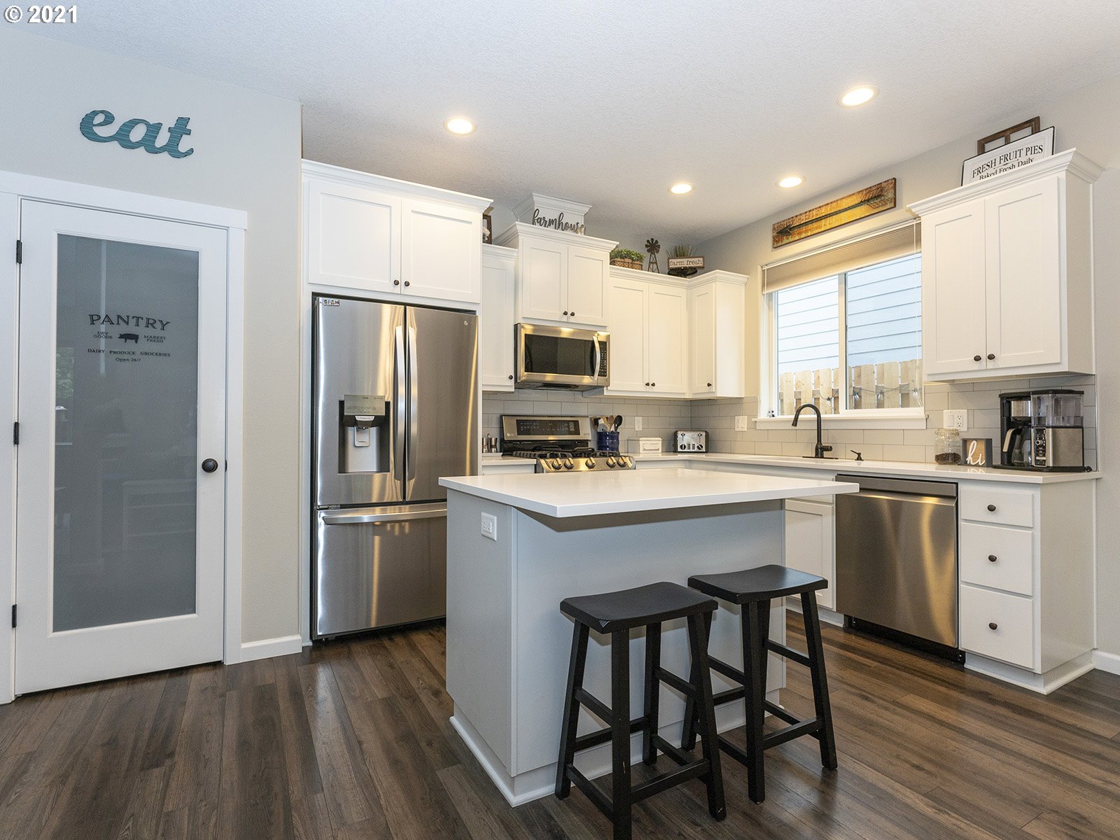 2813 Southeast Baker Avenue Gresham, OR 97080 - Photo 10 of 32 a kitchen with a refrigerator a sink cabinets and wooden floor
