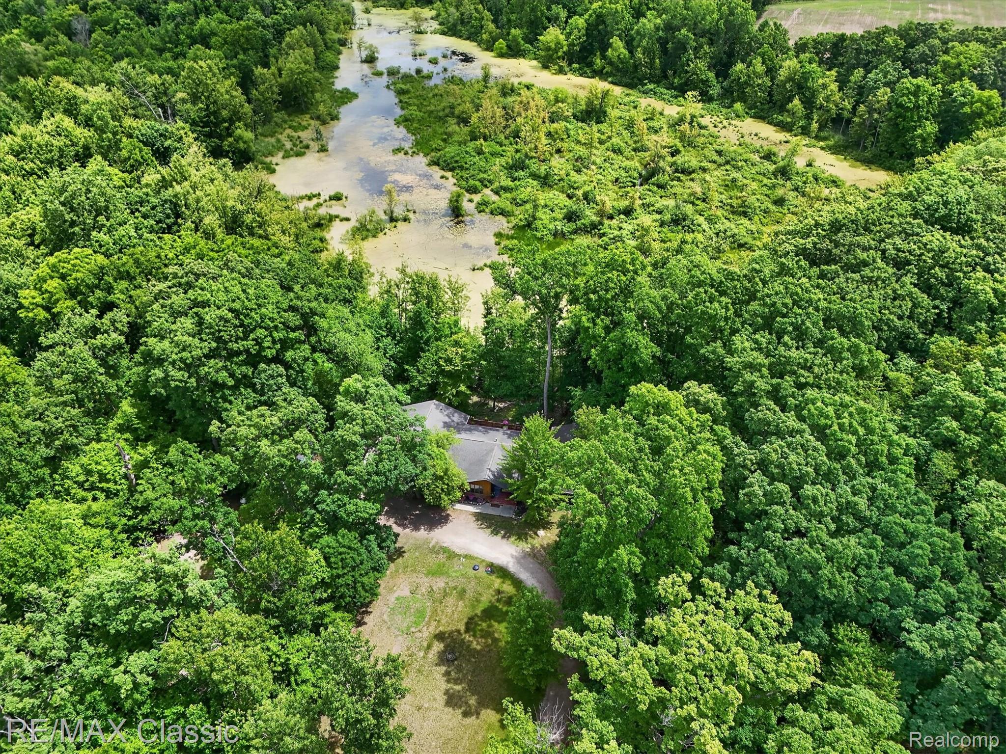 12189 Gage Road Holly, MI 48442 - Photo 63 of 69 Aerial perspective showcasing a secluded residence nestled within extensive mature woodlands