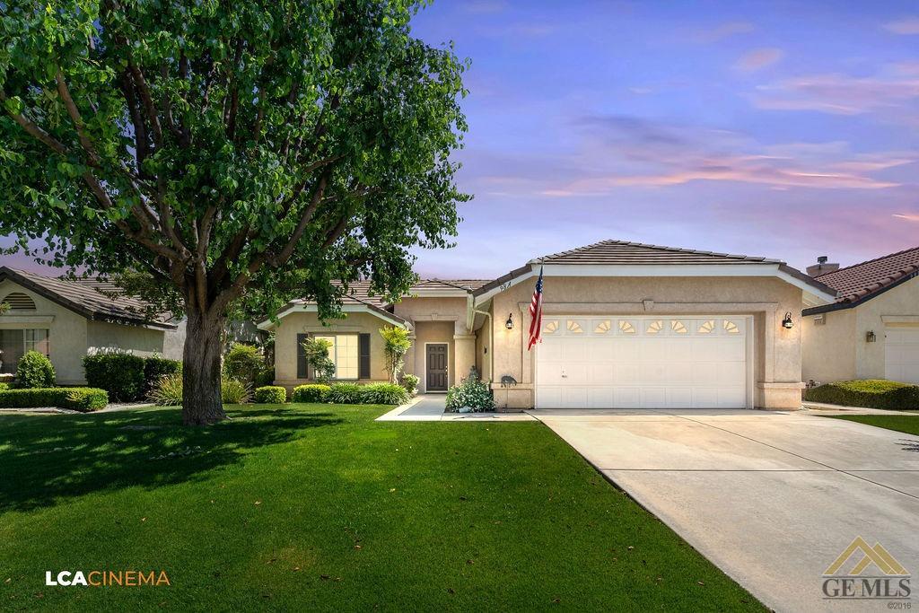 Undisclosed Address Bakersfield, CA 93311 - Photo 1 of 25 a front view of a house with a yard and trees