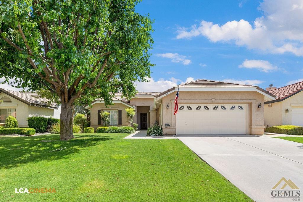 Undisclosed Address Bakersfield, CA 93311 - Photo 2 of 25 a front view of a house with a garden and trees