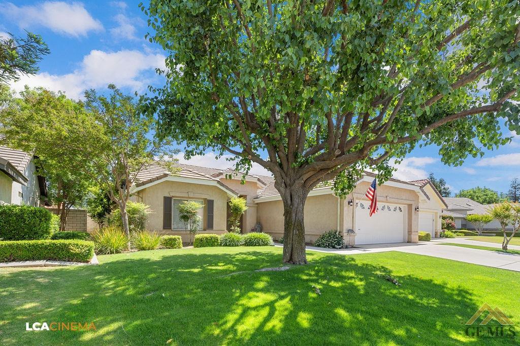 Undisclosed Address Bakersfield, CA 93311 - Photo 3 of 25 a front view of a house with a garden