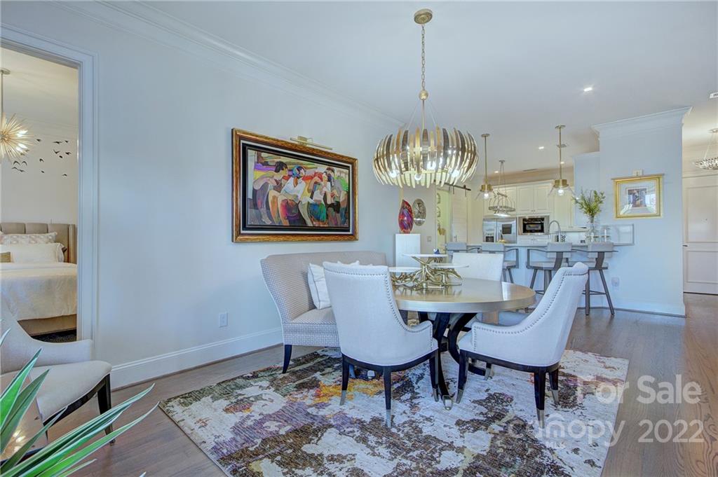 2823 Providence Road, Unit 254 Charlotte, NC 28211 - Photo 13 of 44 a view of a dining room with furniture a rug and wooden floor