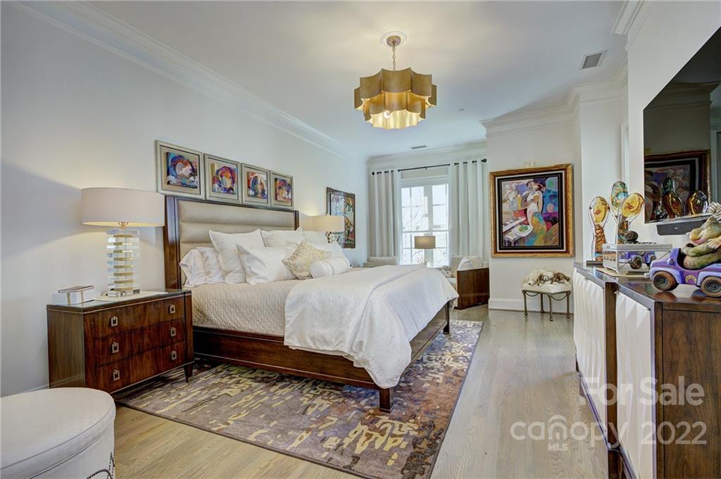 2823 Providence Road, Unit 254 Charlotte, NC 28211 - Photo 15 of 44 a bedroom with a bed and a chandelier