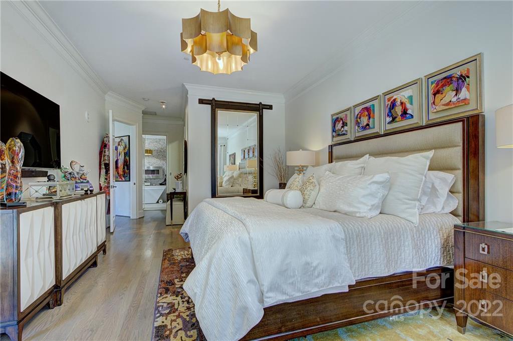 2823 Providence Road, Unit 254 Charlotte, NC 28211 - Photo 16 of 44 a bedroom with a bed and a chandelier