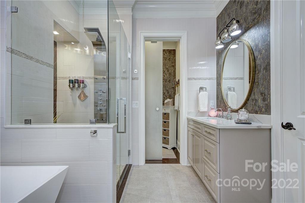 2823 Providence Road, Unit 254 Charlotte, NC 28211 - Photo 19 of 44 a bathroom with a mirror sink and vanity