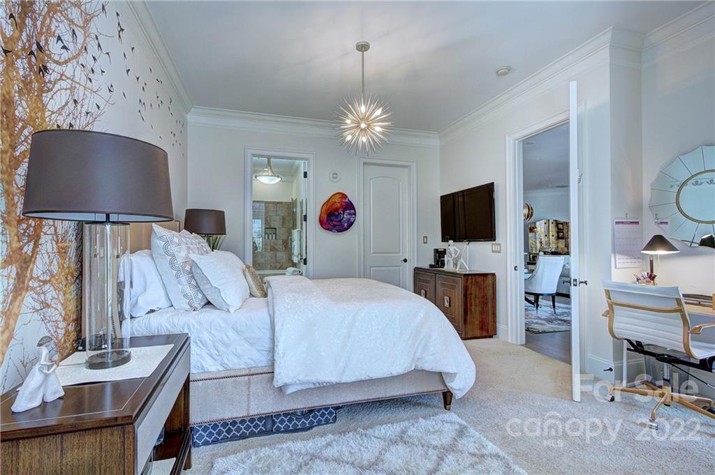 2823 Providence Road, Unit 254 Charlotte, NC 28211 - Photo 22 of 44 a spacious bedroom with a bed and a flat screen tv